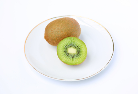 Kiwi fruit in white plate on white backgroundの写真素材