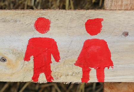 Red Sign of public toilets WC restroom for man and women on woodの写真素材