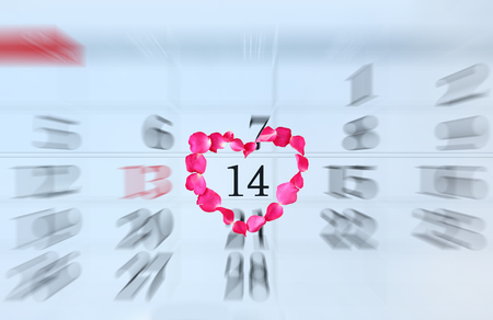 Zoom in Calendar page with pink petals rose in heart shape on February 14 of Saint Valentine's day.の写真素材