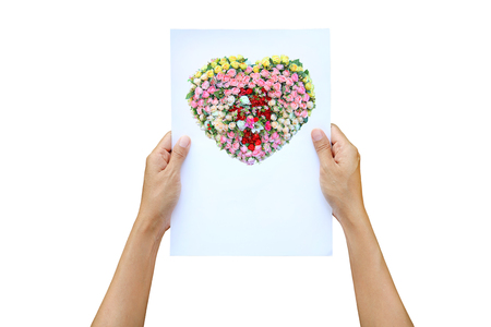 Woman hands holding flat paper with image of heart roses flower isolated on white backgroundの写真素材
