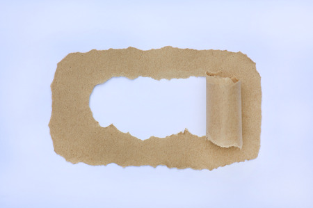 Hole of brown torn paper on white backgroundの写真素材