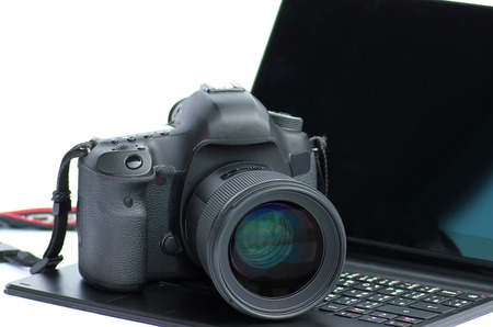 Close-up DSLR Camera lens on laptopの写真素材