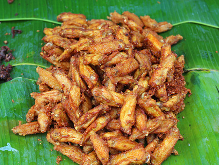 fried chicken wings on banana leafの写真素材