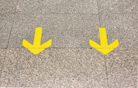 Yellow arrow sign indicate on marble floor, On the subway in thailandの写真素材