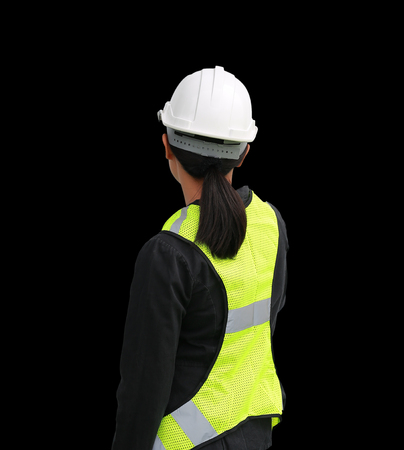Back view of female construction worker isolated on black backgroundの写真素材