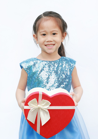 Portrait of a cute little Asian child girl with red heart gift box for Valentine festival isolated on white background.の写真素材