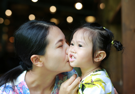 Happy loving family. mother kissing her childの写真素材