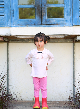 Little farmer girl standing and relax in farmの写真素材