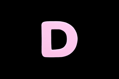 Alphabet letter D symbol of sponge rubber isolated over black backgroundの写真素材