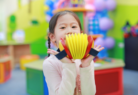 Asian kid girl having fun with Toys, musical instrumentsの写真素材