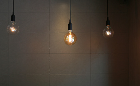 Hanging Lamp decor against gray tile wall backgroundの写真素材