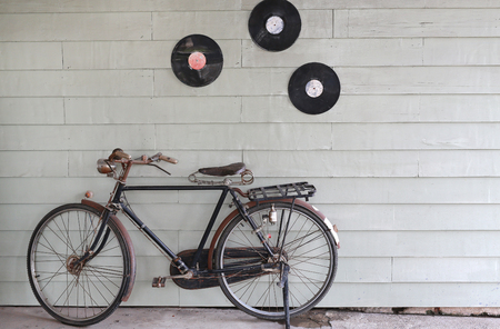 Old Ancient bicycle on the background of a gray wooden wall.の写真素材