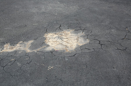 Cracked on asphalt road.