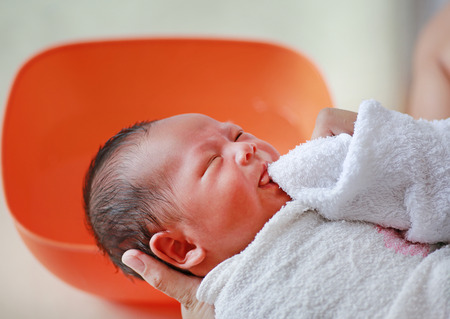 Asian newborn having a bath by mother.の写真素材