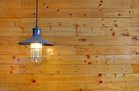 Hanging vintage style Lamp decor against wood wall background with copy space.の写真素材