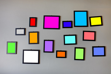 Blank multi color in photo frames on grey cement wall.の写真素材