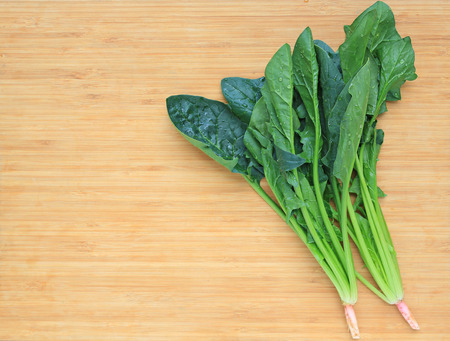 Fresh spinach on wooden board.の写真素材