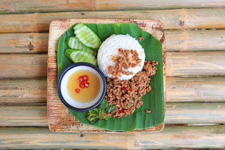Fried pork with sweet basil on rice. Thai popular spicy food.の写真素材