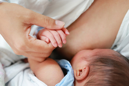 Close up mother breast feeding her newborn child.の写真素材