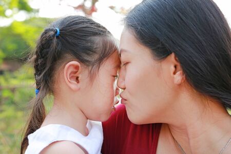 Close-up Mother carry her baby was crying in park.の写真素材