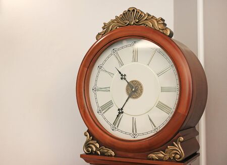 Antique style standing pendulum clock in the house.