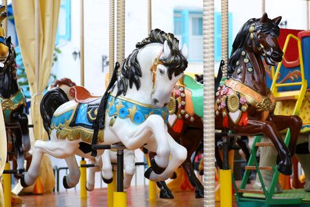 Carousel. Horses on a carnival Merry Go Round.の写真素材