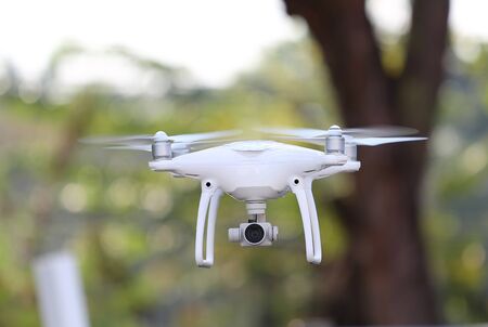 Drone flying in the air at garden outdoor.
