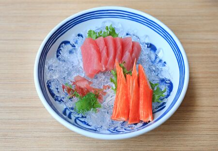 Tuna Sashimi served with Seaweed and Crab sticks on ice. Raw fish in traditional Japanese style food.の写真素材