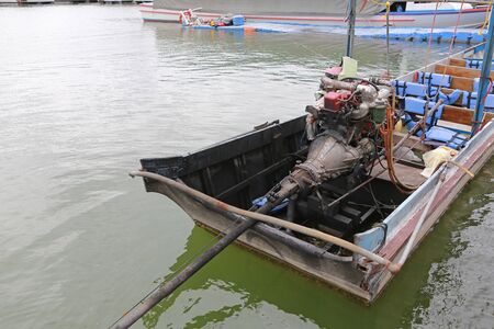 Close-up long-tailed boats on river.