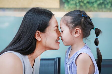 Happy loving family, Close up of mother and child girl kissing.の写真素材