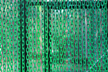Green Plastic Chains curtain as background.
