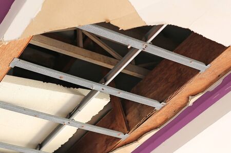Ceiling panels house broken huge hole. Damaged ceiling.の写真素材