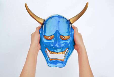 Hands holding blue Kabuki Mask on white background.の写真素材
