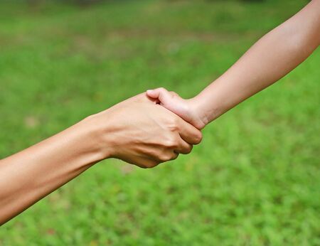 Close-up of mother and child holding by handsの写真素材