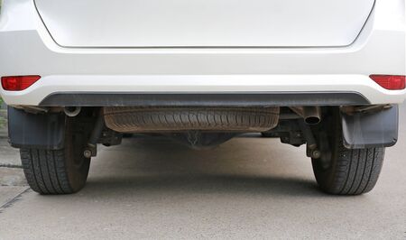 Spare tire under the white car