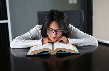 Asian woman relax and lying in the library.の写真素材