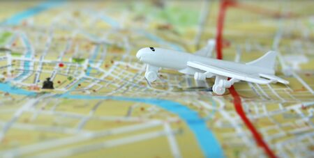 Miniature of a passenger plane flying on the map. Conceptual image for tourism and travel