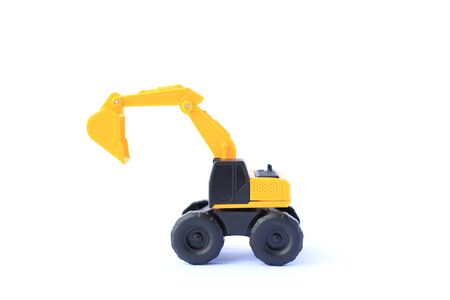 The yellow toy car Excavator isolated on white background. Children's backhole toy model.の写真素材