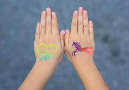 Little girl with arm painted for the party. Body art.の写真素材