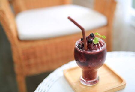 Glass of fresh blueberry smoothie at the cafe.の写真素材