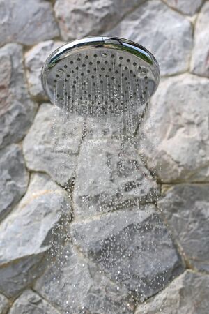 close up on head shower while running waterの写真素材