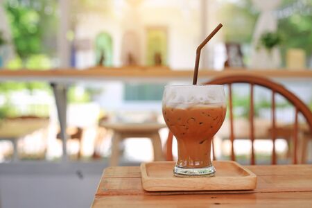 Iced coffee with milk on wooden table at cafe.の写真素材
