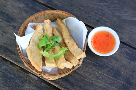 Fried vietnamese white sausage with sweet sauce on wood table.