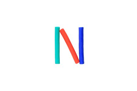 Colorful Alphabet " N " made from Plasticine (Clay) isolated on white background.の写真素材