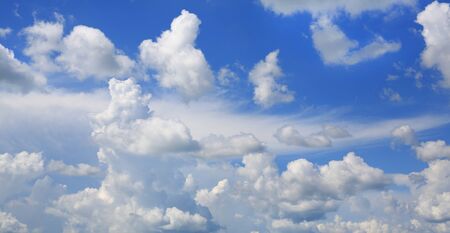 Blue sky and fluffy clouds background.の写真素材