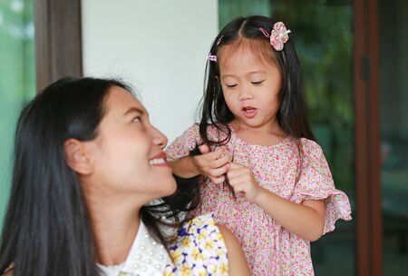 Daughter's is combing mother hair after bathing.の写真素材