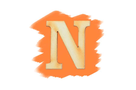 Alphabet letter wooden font on painted orange color isolated on white background. English flat wood character N.の写真素材
