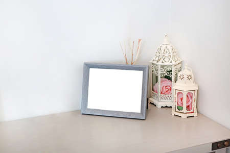 Picture frame with empty place for text or picture on table. Living room interior and home decor...