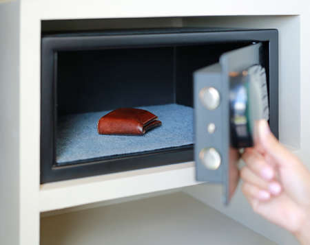 keeping brown wallet in a safe box.の写真素材