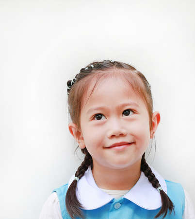 Portrait of little Asian girl in school uniform.